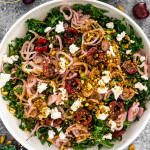 kale cherry salad in a white bowl.