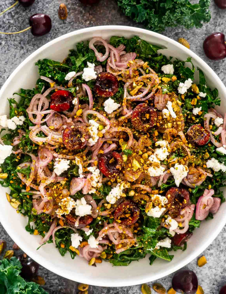 kale cherry salad in a white bowl.