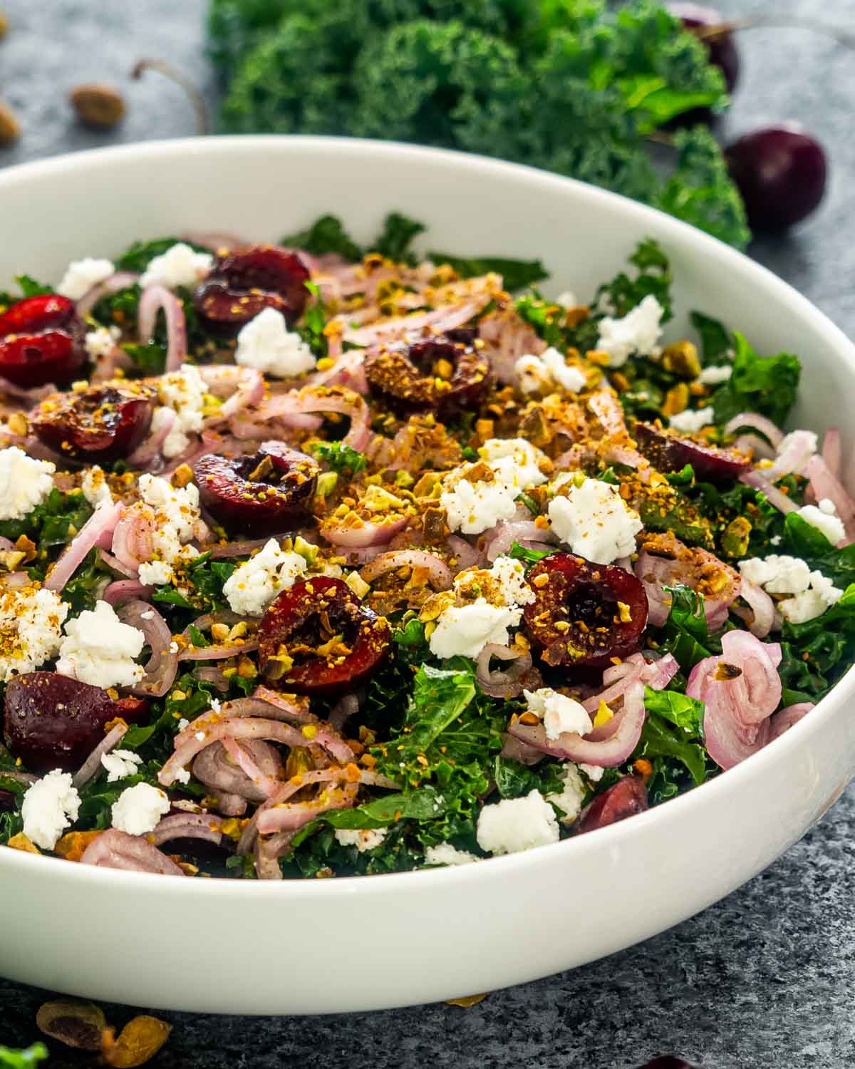 kale cherry salad in a white bowl.