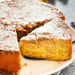 a slice cut out of apple cake on a platter.