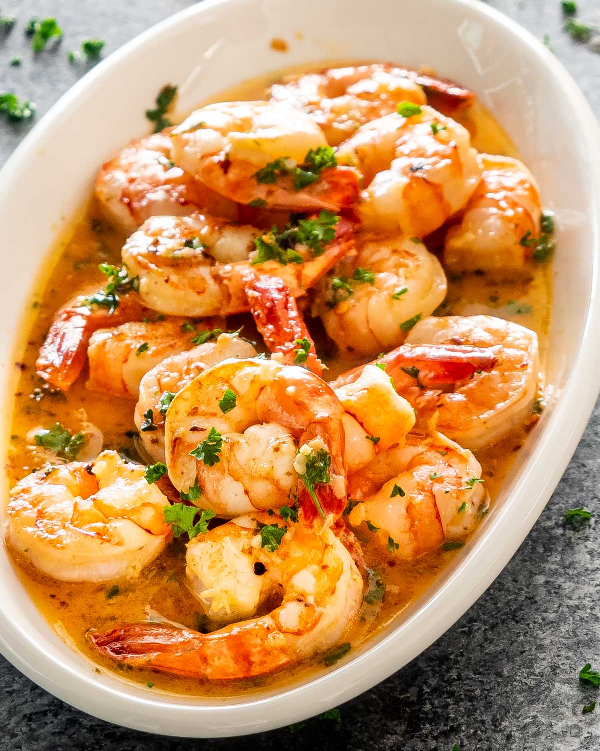 garlic butter shrimp in a white platter.