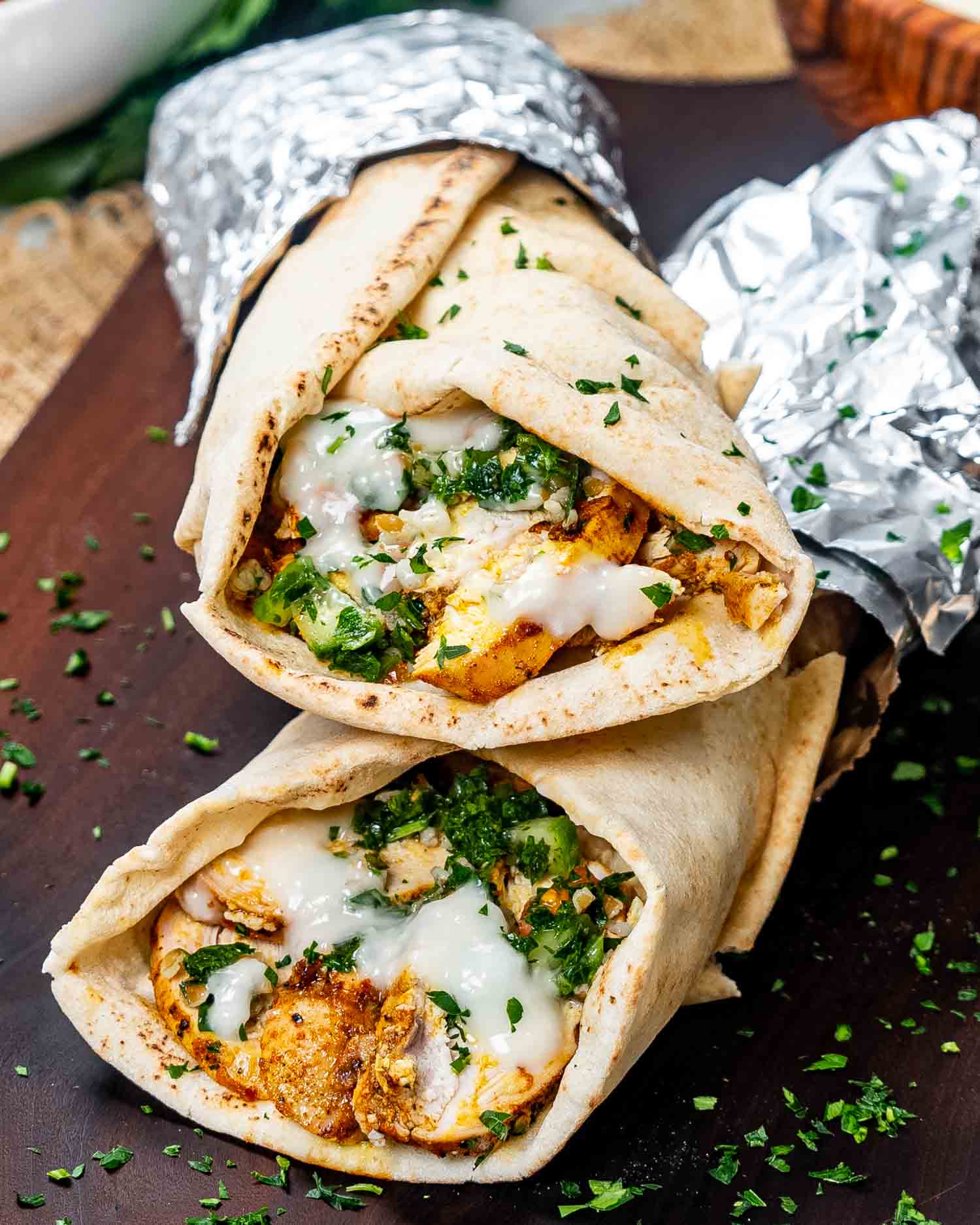 two chicken shawarma wraps stacked on top of each other.