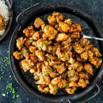 chinese honey chicken on a serving platter garnished with sesame seeds.