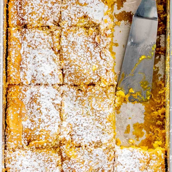 gooey butter cake in a baking dish cut into slices.