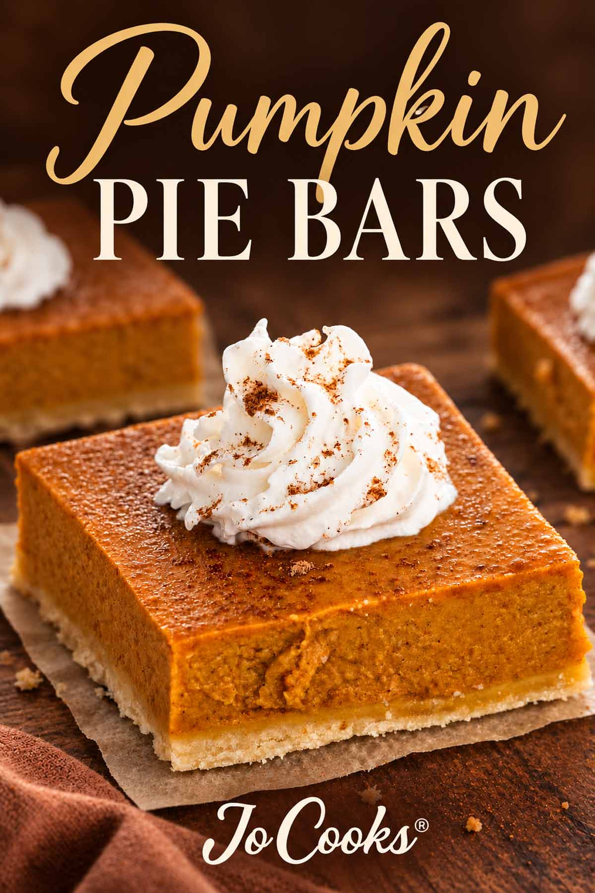 Pumpkin pie bar topped with cinnamon-dusted whipped cream, with gold and ivory Pumpkin Pie Bars text and Jo Cooks logo.