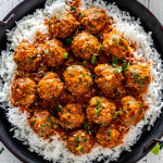 red curry turkey meatballs over a bed of rice.