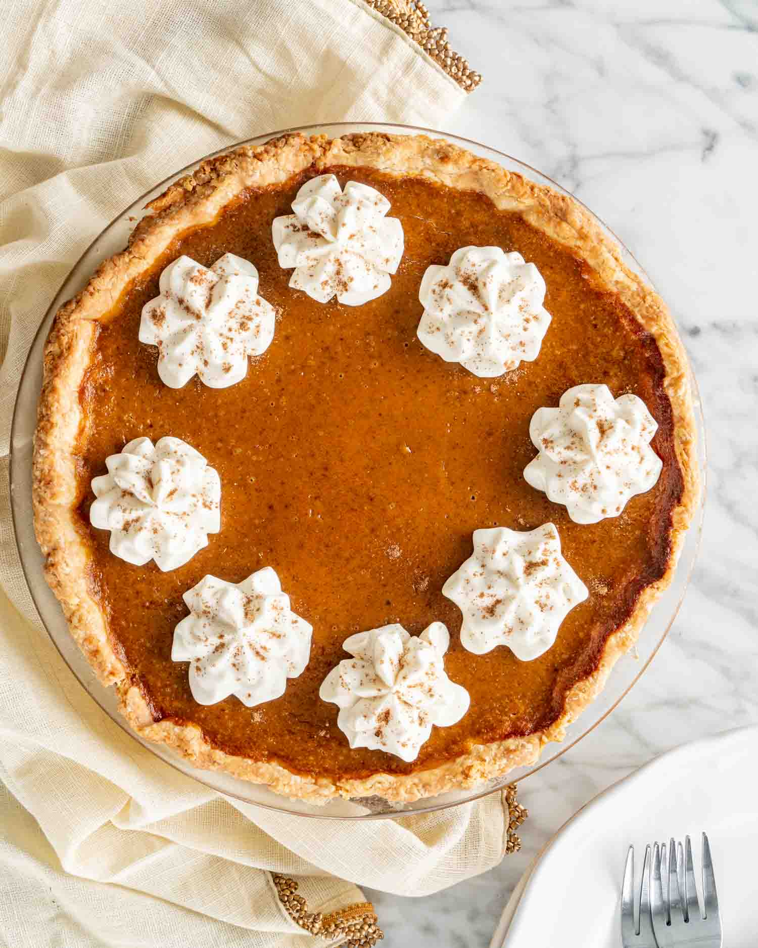 a freshly baked pumpkin pie with whipped cream.