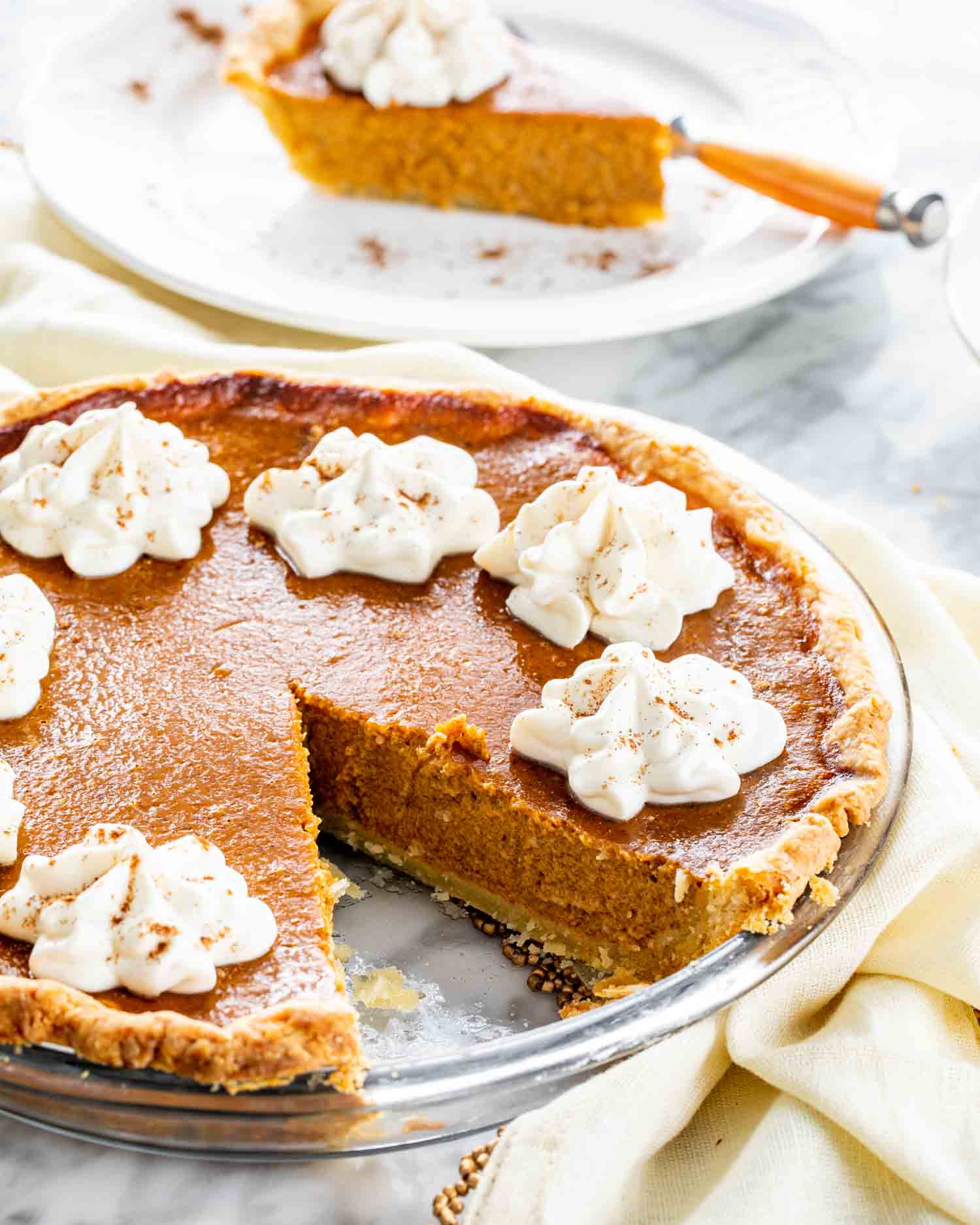a freshly baked pumpkin pie with whipped cream.