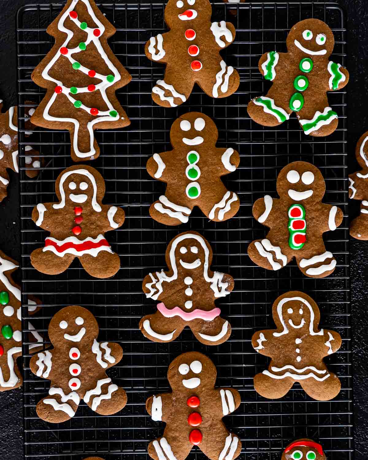 beautifully decorated gingerbread cookies on a cooling rack.