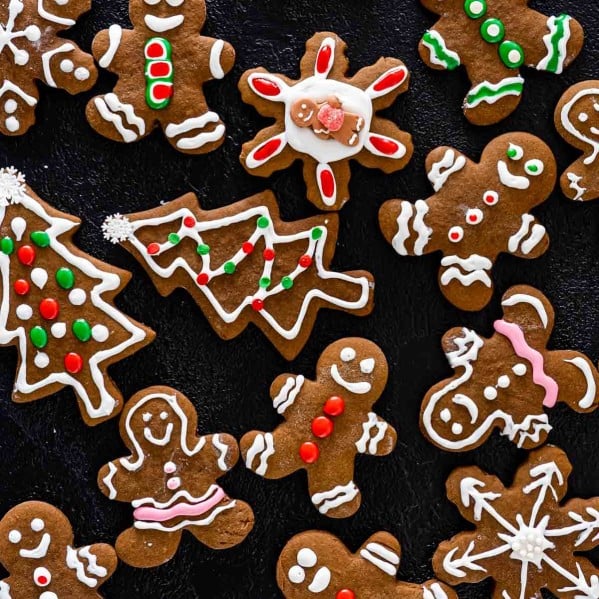 beautifully decorated gingerbread cookies on a board.