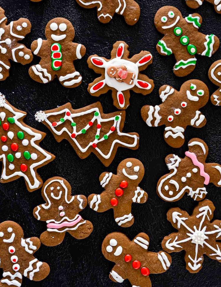 beautifully decorated gingerbread cookies on a board.