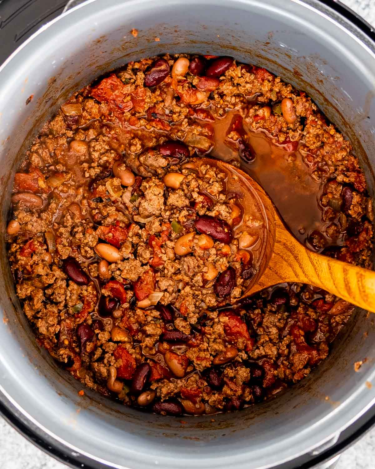 chili made in an instant pot with a ladle inside.