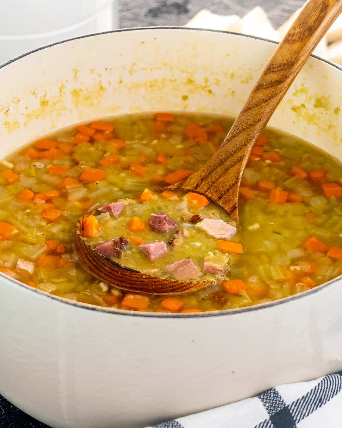 split pea soup in a dutch oven with a ladle in it.