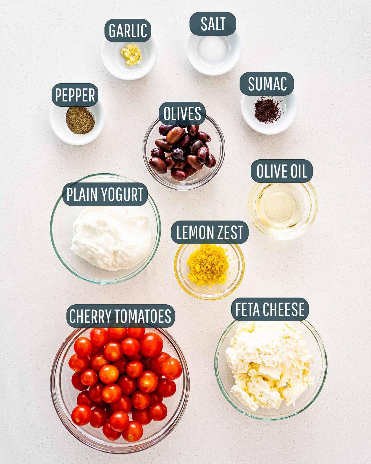 overhead shot of ingredients needed to make whipped feta dip with roasted tomatoes.