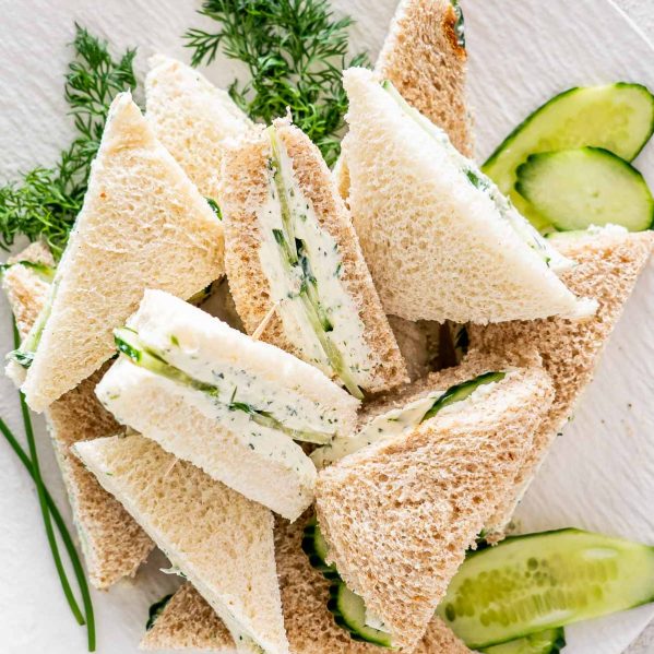mini cucumber sandwiches on a white plate.
