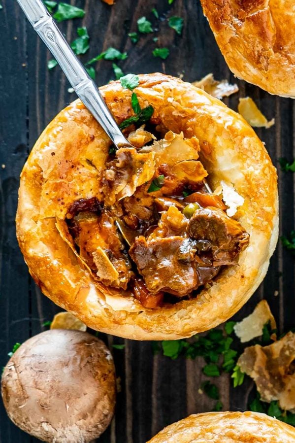 a fork inside a beef pot pie that was freshly baked.