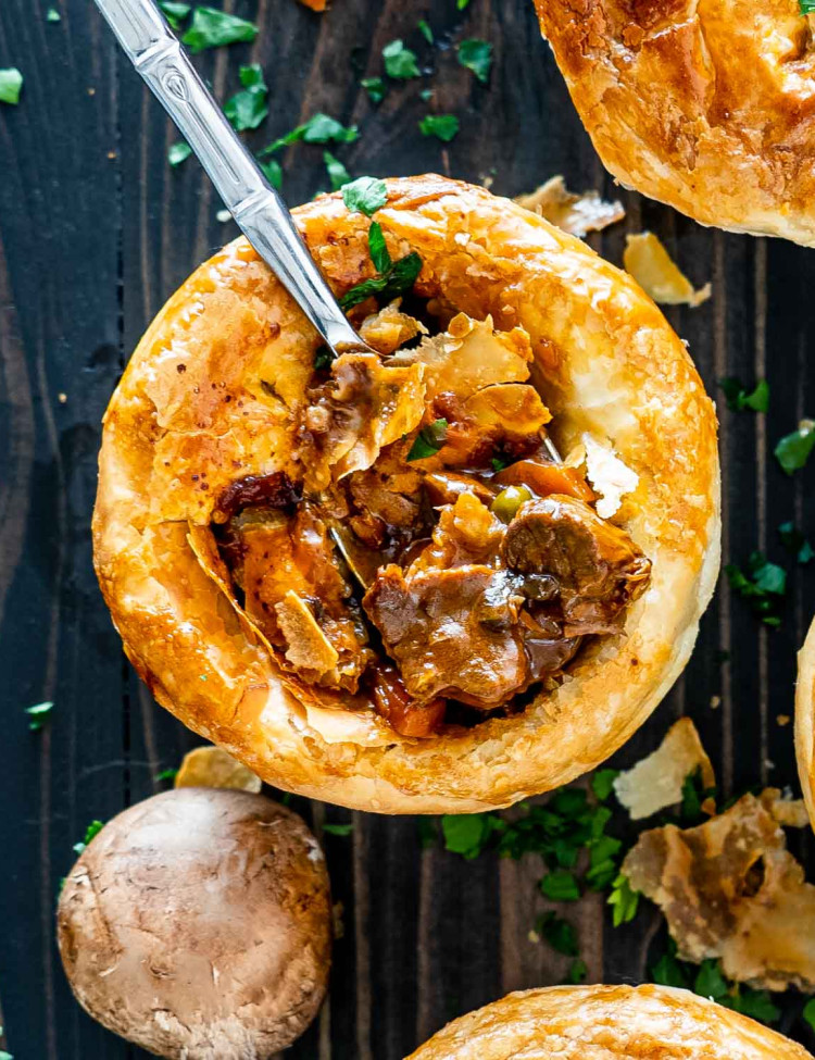 a fork inside a beef pot pie that was freshly baked.