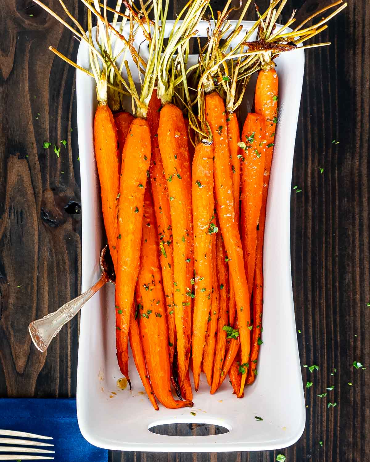 freshly made honey roasted carrots in a white bowl.