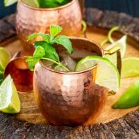overhead shot of two irish mule cocktails garnished with mint and lime wedges.