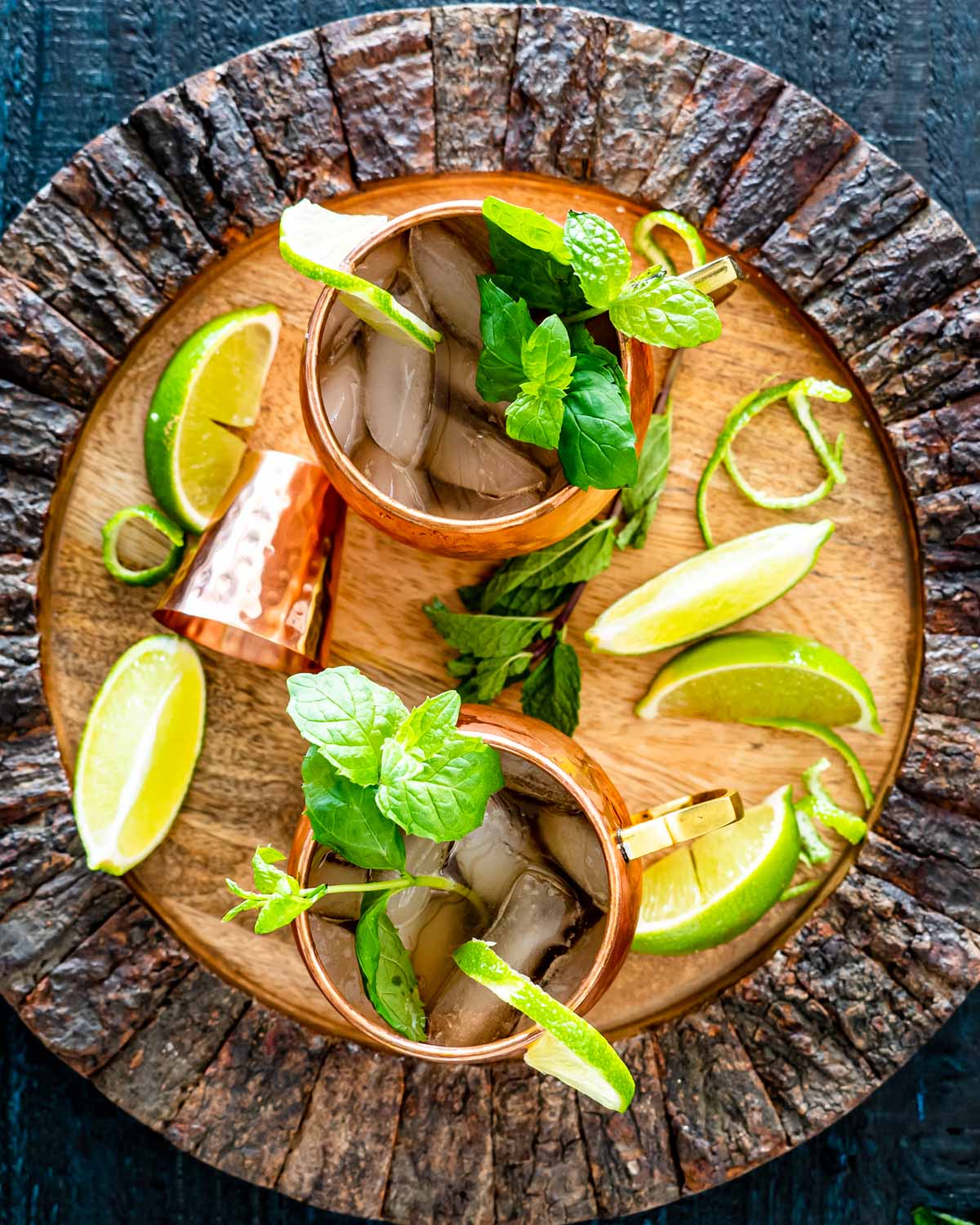 overhead shot of two irish mule cocktails garnished with mint and lime wedges.