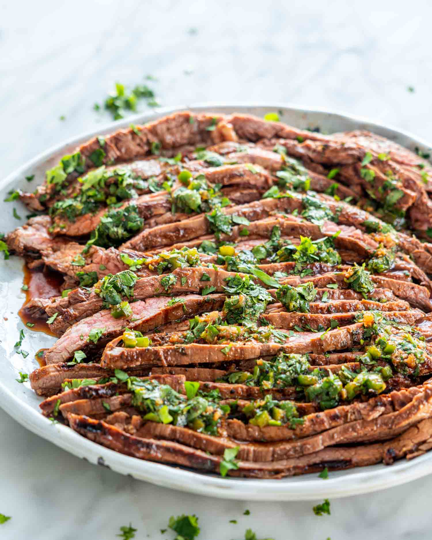 sliced carne asada on a plate.