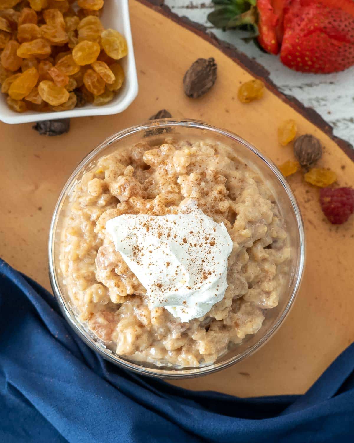 rice pudding in a bowl topped with whipped cream.