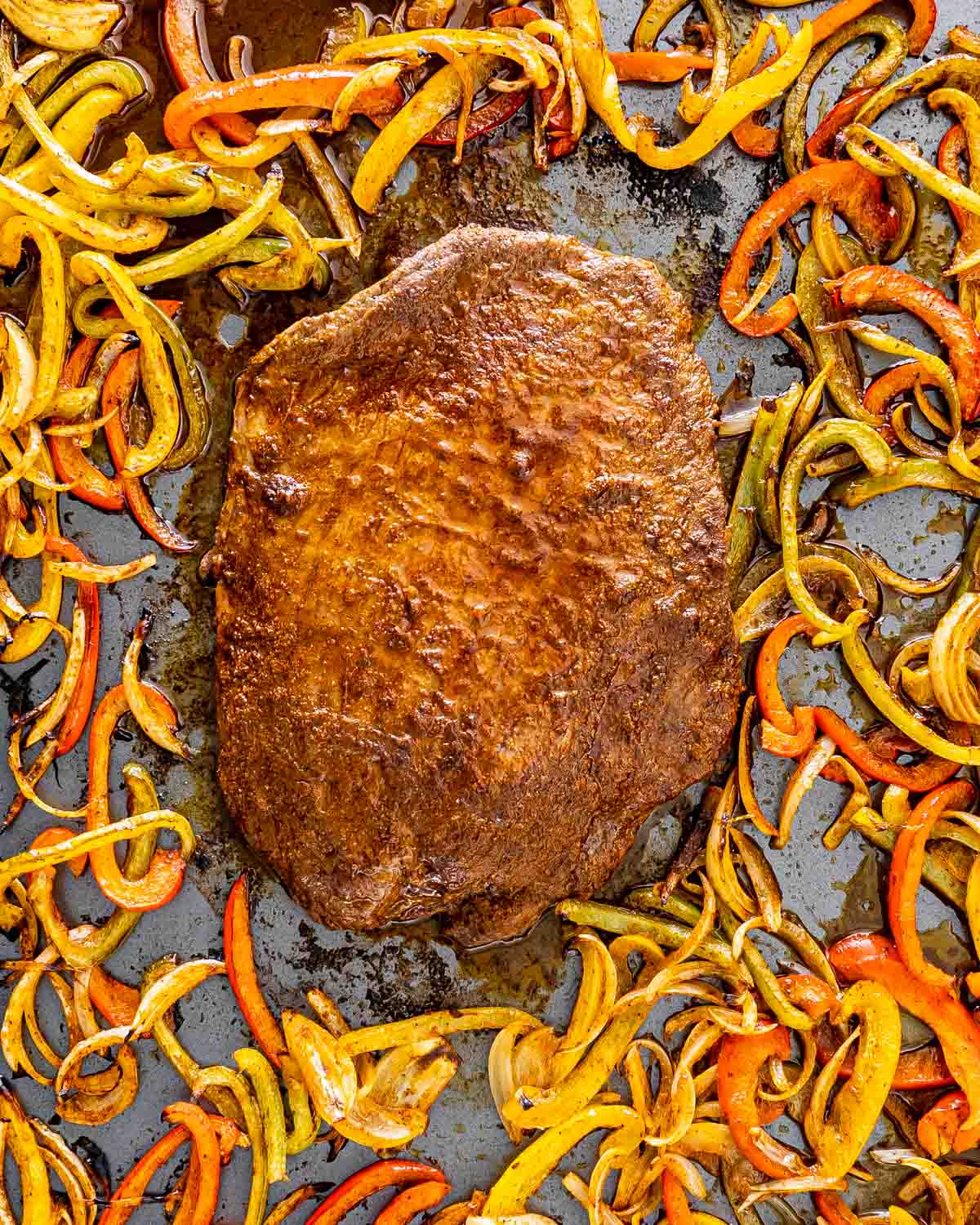 steak fajitas on a sheet pan fresh out of the oven.