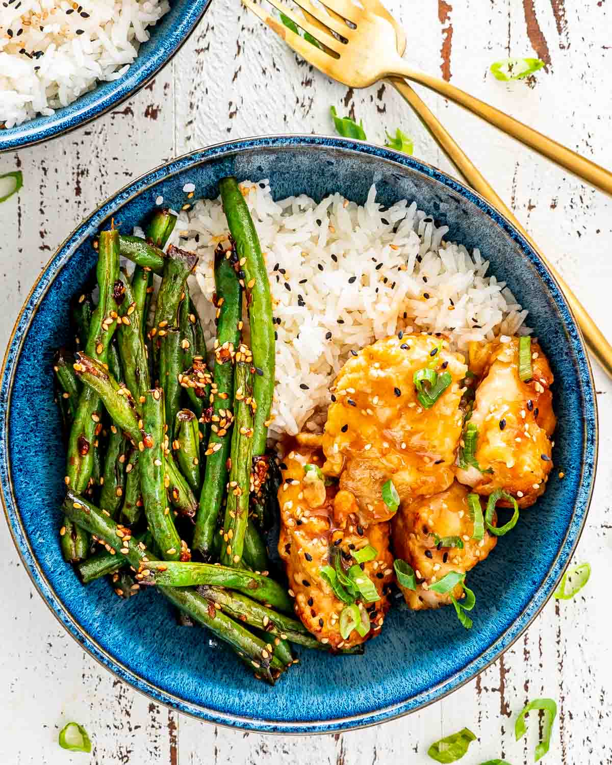 lemon chicken with asian green beans in a blue bowl.