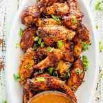 air fryer thai chicken wings in a white platter.