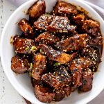 asian steak bites in a white bowl.