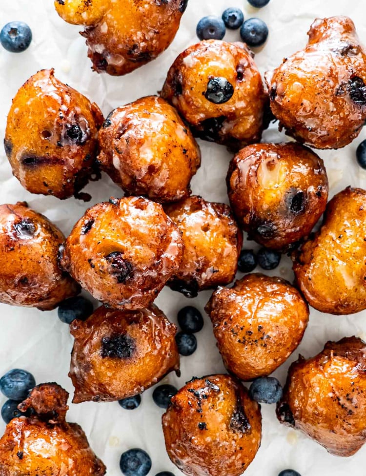 blueberry fritters on a piece of parchment paper.