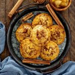 a few apple hand pies on a serving platter drizzled with caramel.