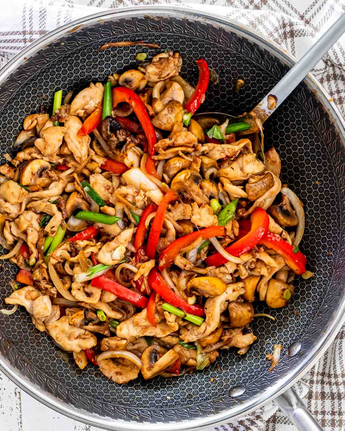 chicken mushroom stir fry freshly made in a wok.