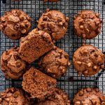 double chocolate chip muffins on a black cooling rack.