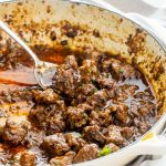 freshly made lamb korma in a beige braiser.