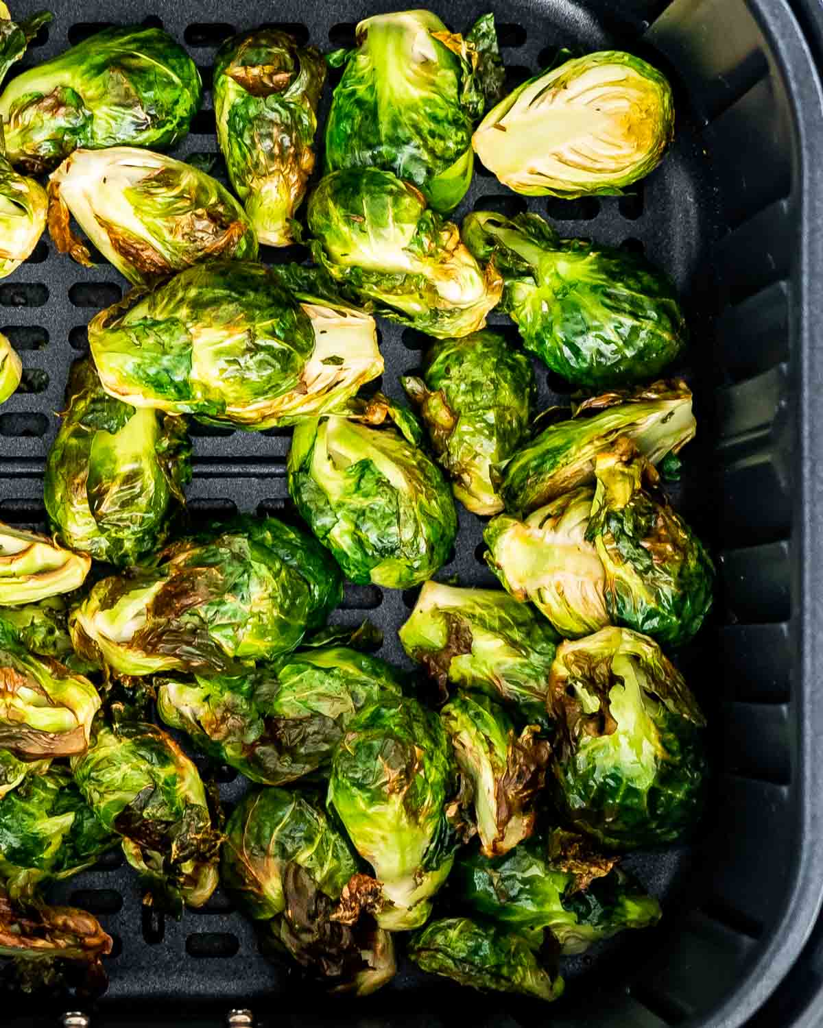 brussels sprouts in an air fryer basket.