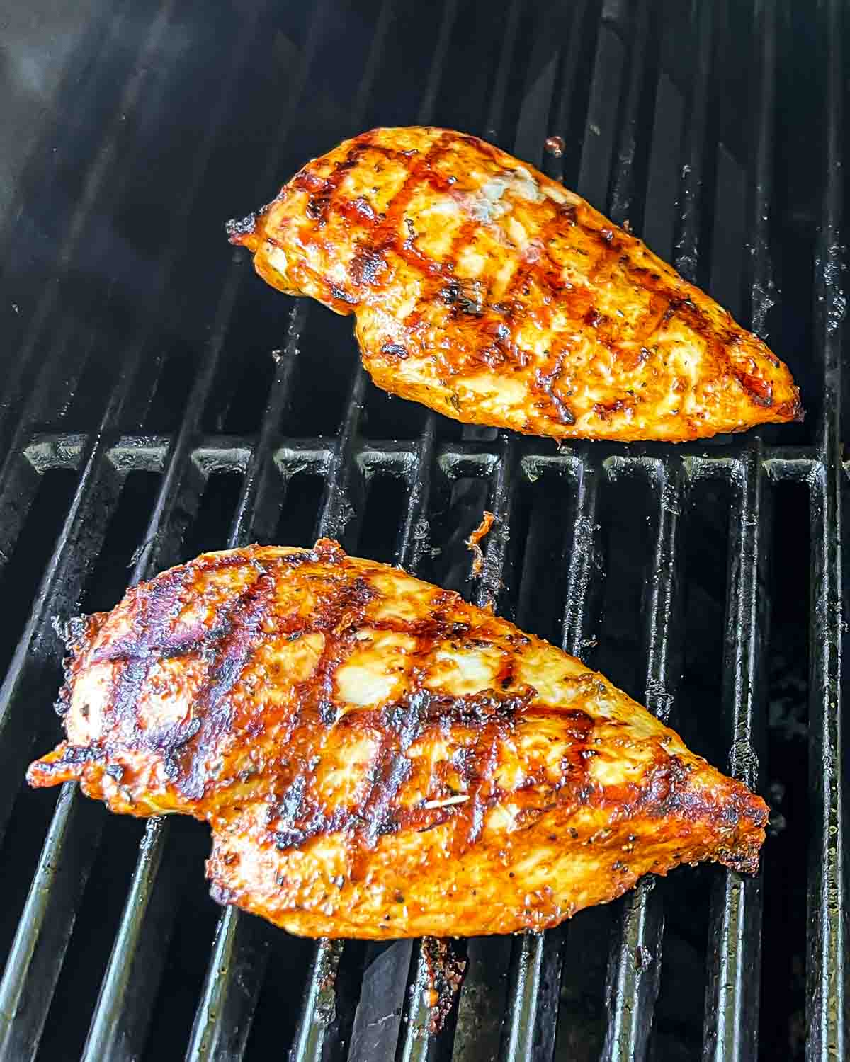 chicken breast being grilled on a grill.