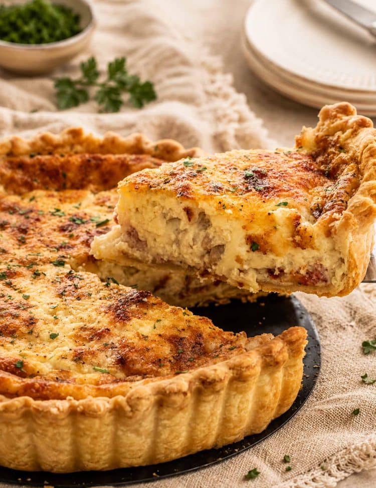 side view shot of a slice of quiche being lifted from the quiche lorraine.
