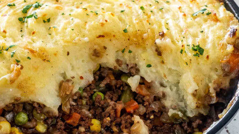 skillet shepherd's pie in a cast iron skillet with a portion taken out.