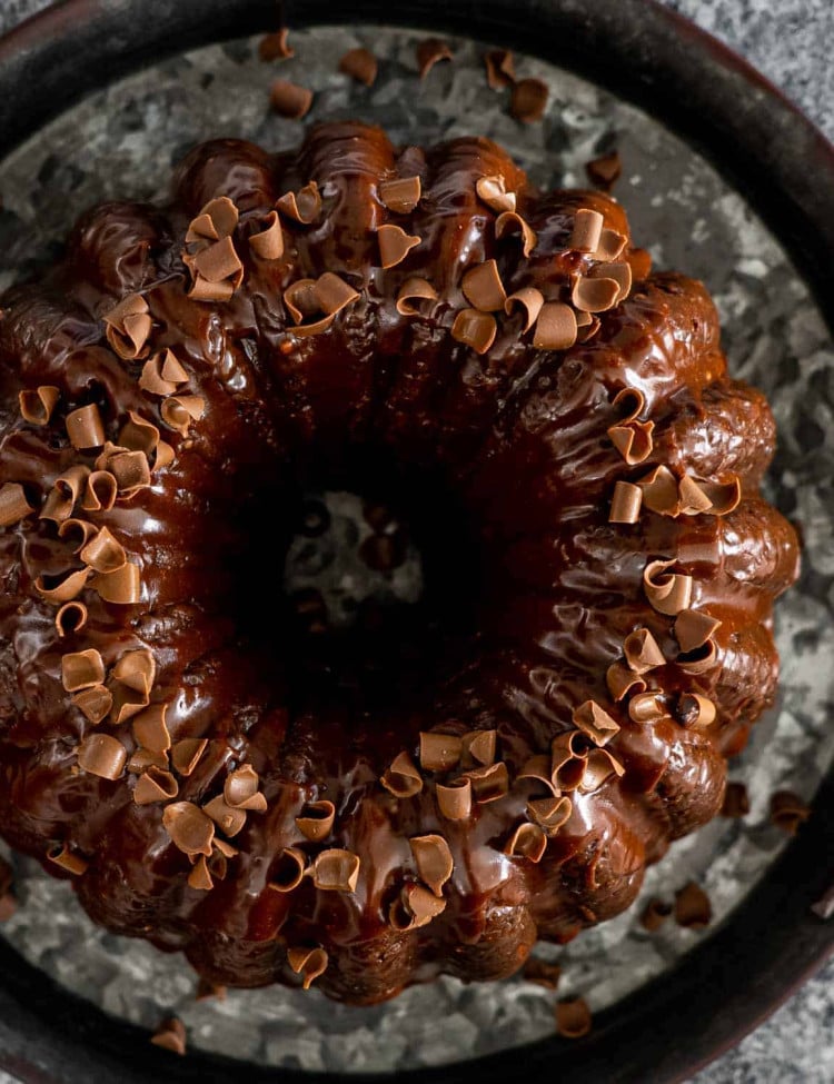 chocolate bundt cake topped with chocolate ganache and sprinkled with chocolate shavings.