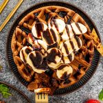 chocolate waffles with bananas and chocolate sauce.