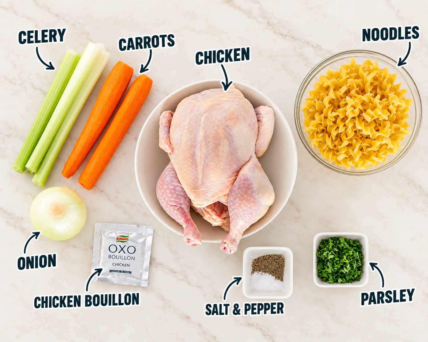 Homemade chicken noodle soup ingredients arranged on a warm countertop, including whole chicken, noodles, carrots, celery, onion, and seasonings.