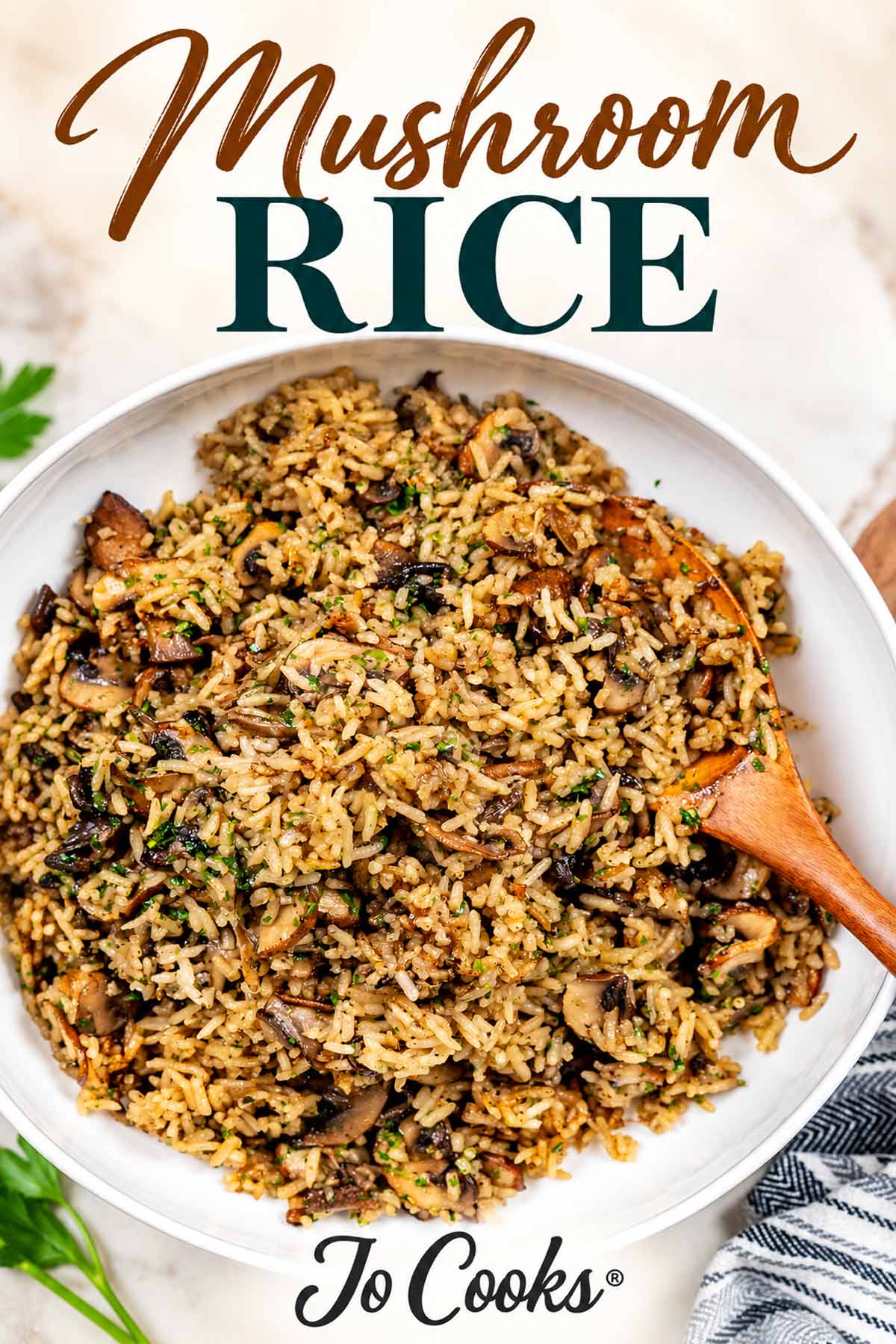 Mushroom rice with sliced mushrooms and parsley in a white serving bowl, with recipe title and Jo Cooks logo.