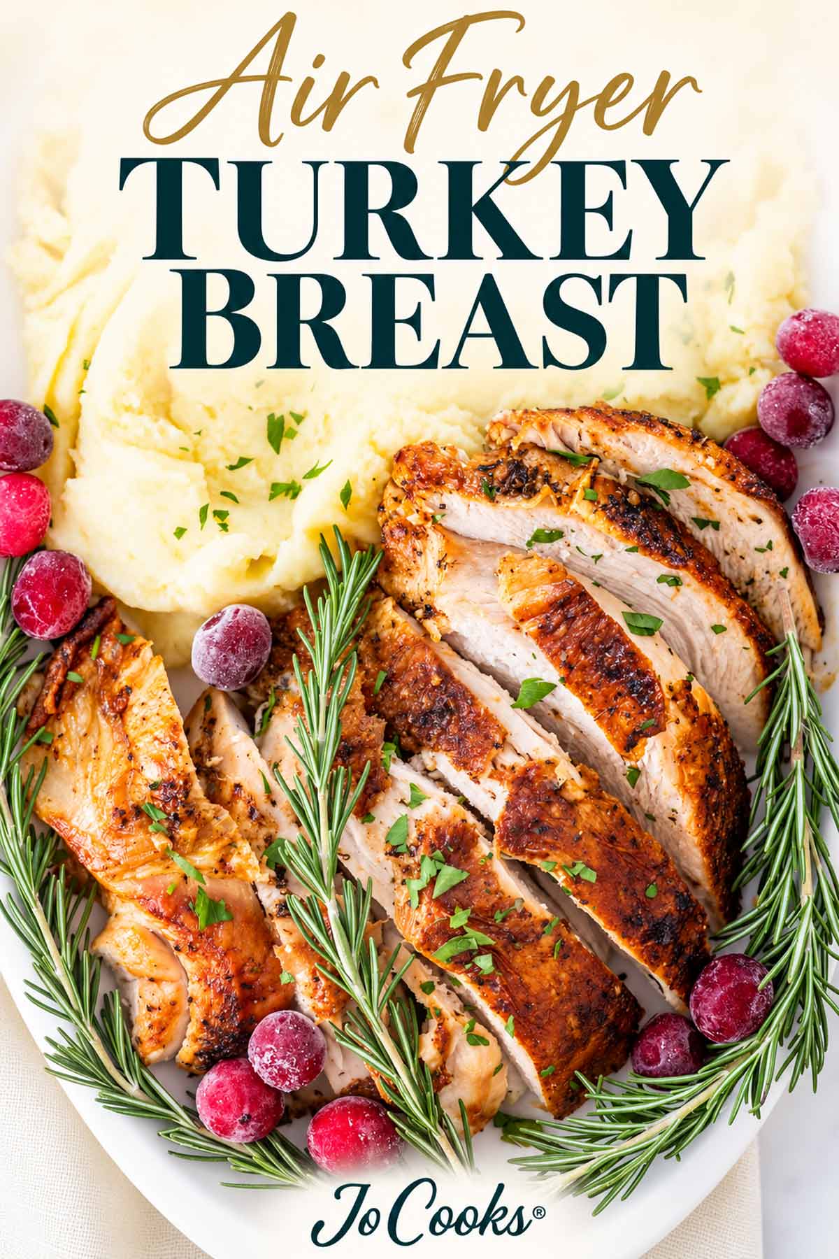 Overhead sliced air fryer turkey breast surrounded by rosemary and cranberries, with mashed potatoes, recipe title, and Jo Cooks logo.