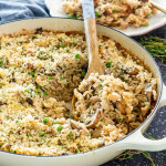 turkey rice casserole in a beige braiser with a spoon inside.