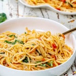 a serving of freshly made pasta pomodoro in a white bowl.