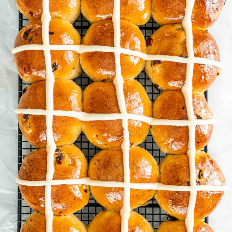 hot cross buns cooling on a cooling rack.