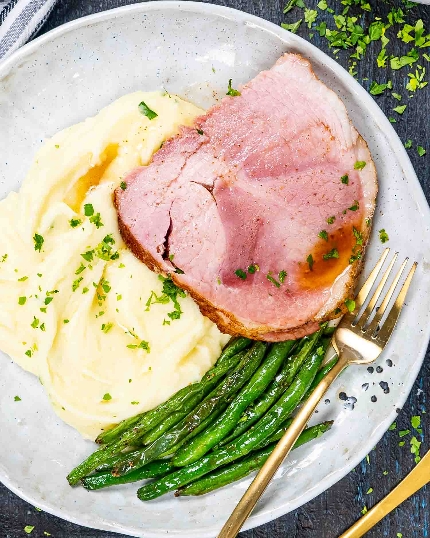 instant pot ham with mashed potatoes and green beans on a plate.