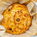 no knead jalapeno cheddar bread in a dutch oven fresh out of the oven.