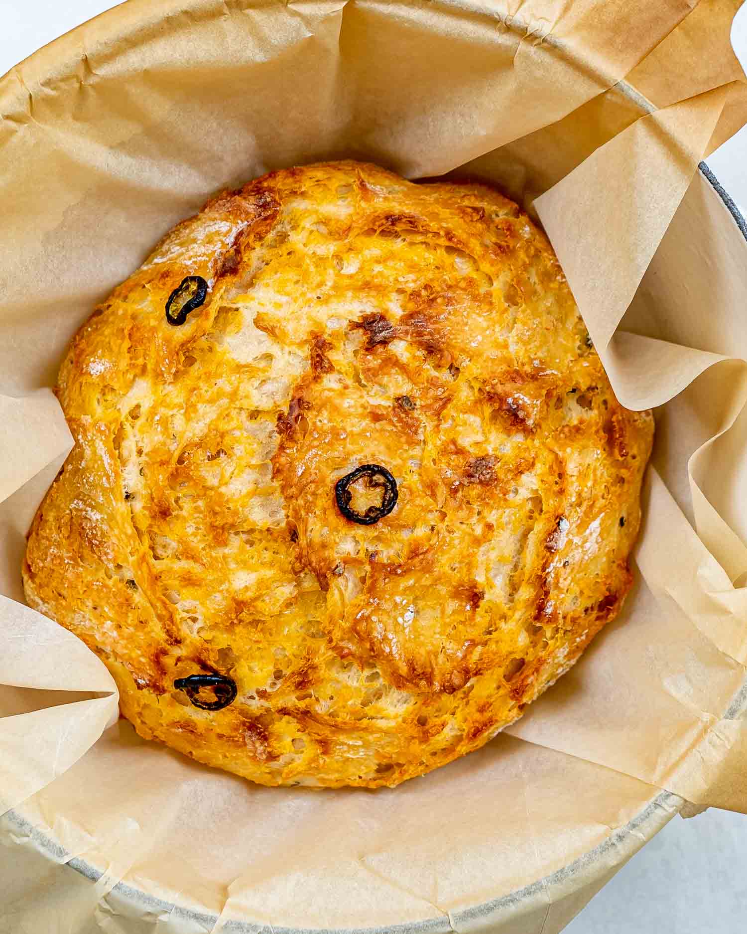 no knead jalapeno cheddar bread in a dutch oven fresh out of the oven.